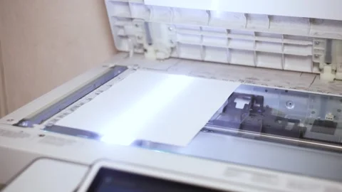 An office scanner performs the process of scanning an A4 document Stock Footage 294628106