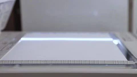 An office scanner performs the process of scanning an A3 document Stock Footage 294976243