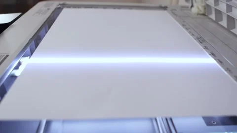 An office scanner performs the process of scanning an A3 document Stock Footage 294976247