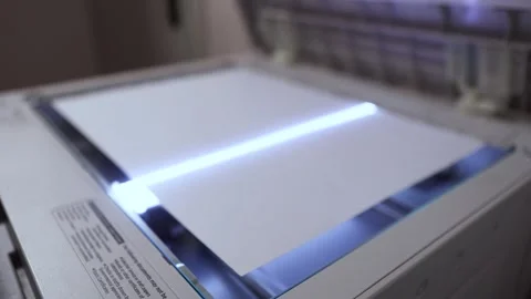 An office scanner performs the process of scanning an A3 document Stock Footage 294976259