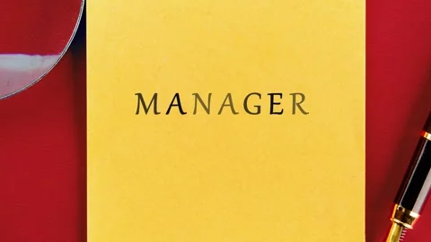 In an office setting, different sticky notes and papers show the word manager. Stock Footage 341479008