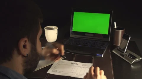 Office Setup Laptop With Green Screen And A Young Man Signing Papers Stock Footage 35770465