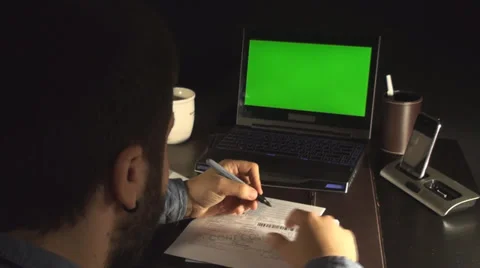 Office Setup Laptop With Green Screen And A Young Man Talking On The Phone Stock Footage 35770643