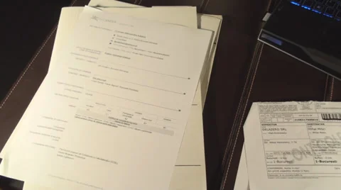 Office Setup Piled Up Papers And A Laptop Office Hours, Late, Night,Pan-Shot Stock Footage 35770656