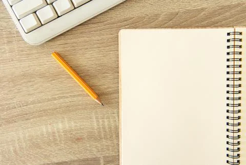 Office simple background pattern with white paper notebook pencil and keyboar Stock Photos