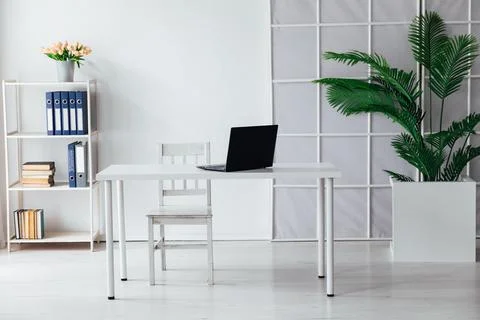 An office space with a laptop on the table Stock Photos