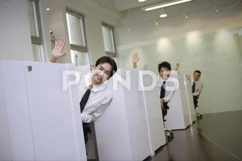 Office staff greeting from office cubicles Stock Photos