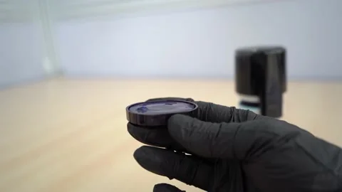Office Stamp with Rolling Wheels, Resting on an Pad Filled with Blue Ink. Video stock 156253677