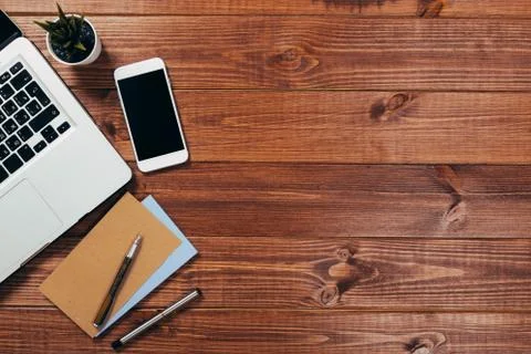Office stuff with notepad, laptop and coffee cup mouse notepad top view shot. Stock Photos