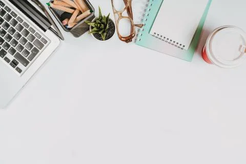 Office stuff with with notepad, laptop and coffee, glasses, notepad top view Stock Photos