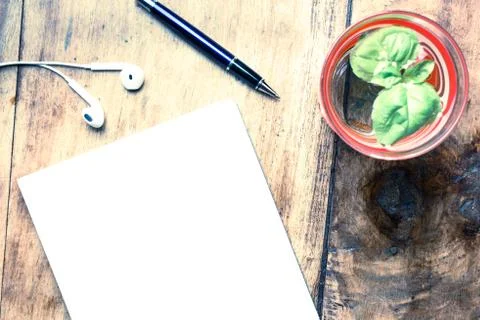 Office stuff with notepad, pen, hand, glass of water with fresh mint. Top vie Stock Photos