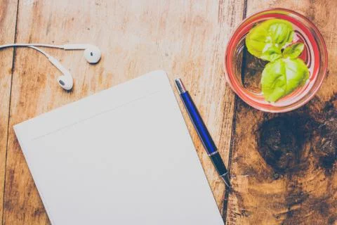 Office stuff with notepad, pen, hand, glass of water with fresh mint. Top vie Stock Photos