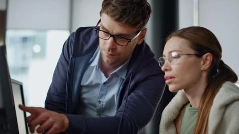 Office supervisor coaching intern closeup. Focused colleagues team analyse data Photos