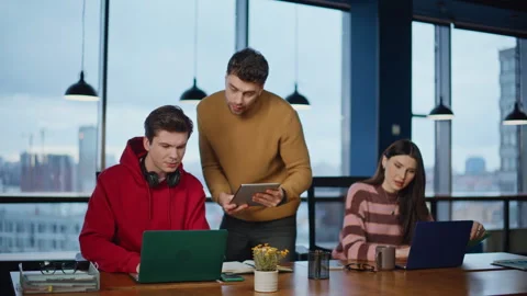 Office supervisor looking interns work in corporate workspace. Friendly trainee Stock Footage 340072850