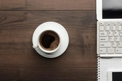 Office table and cup of coffee overhead Stock Photos