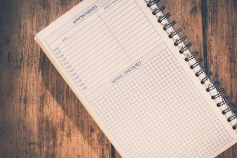 Office table concept. Blank notebook with appointments list and notes/sketche Stock Photos