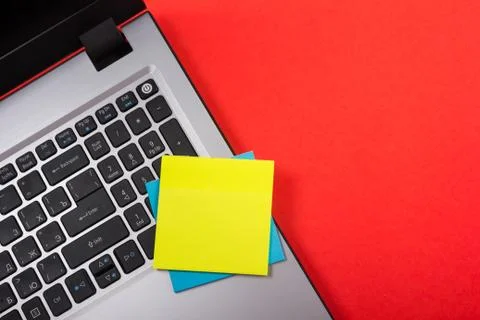 Office table desk with set of colorful supplies, white blank note pad, cup, pen Stock-Fotos