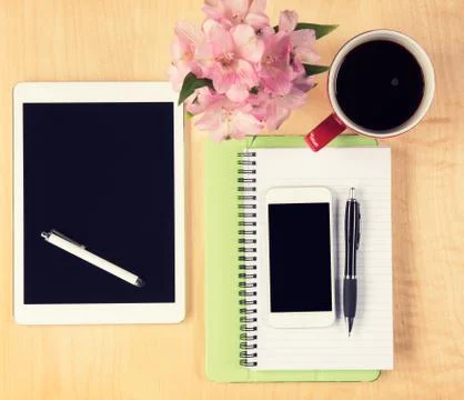 Office table with digital tablet, smartphone, reading glasses and cup of coffee Stock Photos