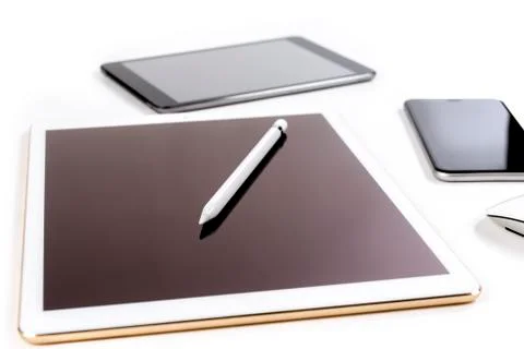 Office table with digital tablet, smartphone and pencil on isolated pure whit Stock Photos
