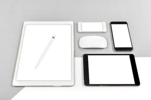 Office table with digital tablet, smartphone, mouse and pencil on isolated pu Stock Photos