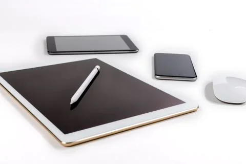 Office table with digital tablet, smartphone, mouse and pencil on isolated pu Stock Photos