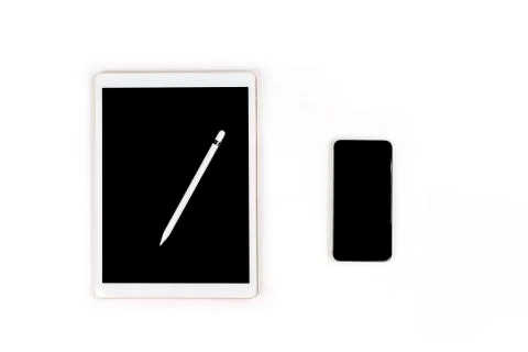 Office table with digital tablet, smartphone and pencil on isola Stock Photos