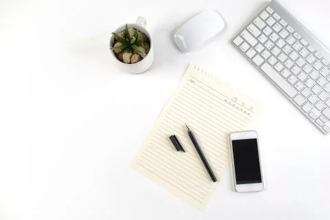 Office table with keyboard, mouse, notebook and smartphone on white backgroun Stock Photos