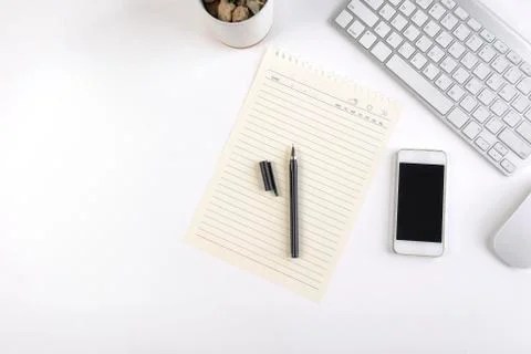 Office table with keyboard, mouse, notebook and smartphone on white backgroun Stock Photos