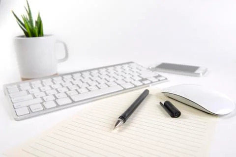 Office table with keyboard, mouse, notebook and smartphone on white backgroun Stock Photos