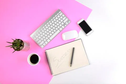Office table with keyboard, mouse, notebook and smartphone on modern two tone Stock Photos