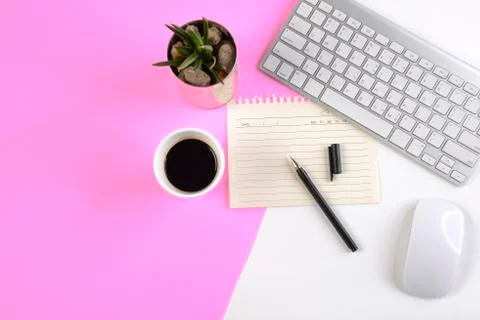 Office table with keyboard, mouse, notebook and smartphone on modern two tone Stock Photos