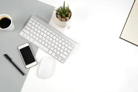 Office table with  keyboard, mouse, notebook and smartphone on modern two ton Stock Photos