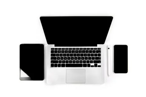 Office table with laptop computer, digital tablet, smartphone, pencil and mou Stock Photos