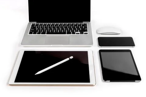 Office table with laptop computer, digital tablet, smartphone, pencil and mou Stock Photos
