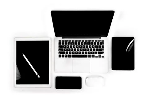Office table with laptop computer, digital tablet, smartphone, pencil and mou Stock Photos