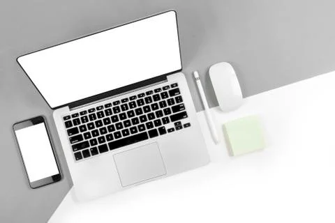 Office table with laptop computer, digital tablet, smartphone, pencil and mou Stock Photos