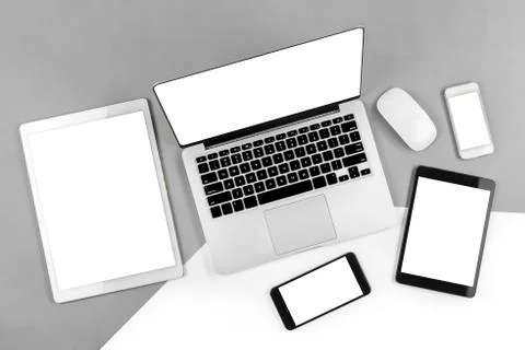 Office table with laptop computer, digital tablet, smartphone and mouse on is Stock Photos