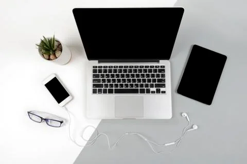 Office table with laptop computer, digital tablet and mobile phone on modern  Stock Photos