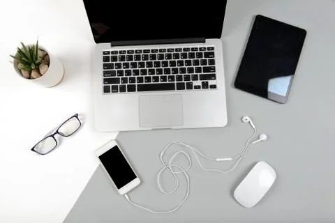 Office table with laptop computer, digital tablet and mobile phone on modern  Stock Photos