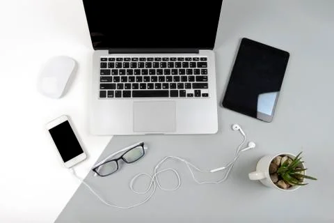 Office table with laptop computer, digital tablet and mobile phone on modern  Stock Photos