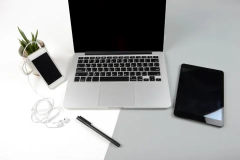 Office table with laptop computer, digital tablet and mobile phone on modern  Stock Photos
