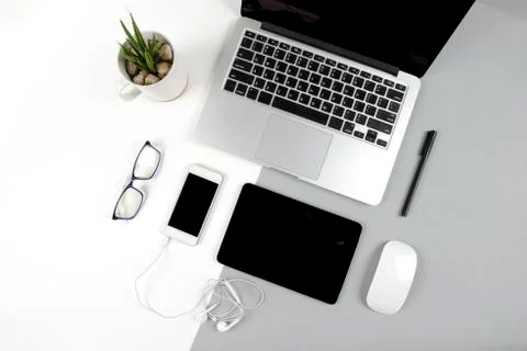 Office table with laptop computer, digital tablet and mobile phone on modern  Stock Photos