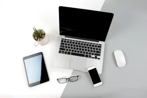 Office table with laptop computer, digital tablet and mobile phone on modern  Stock Photos