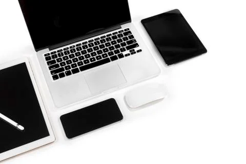 Office table with laptop computer, digital tablet, smartphone, pencil and mou Stock Photos