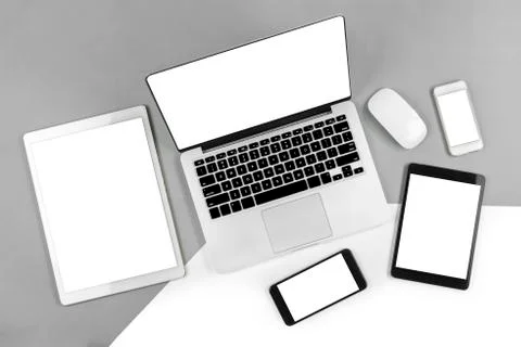 Office table with laptop computer, digital tablet, smartphone and mouse on is Stock Photos