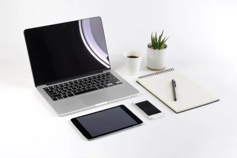 Office table with laptop computer, notebook, digital tablet and smartphone on Stock Photos