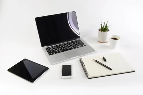 Office table with laptop computer, notebook, digital tablet and smartphone on Stock Photos