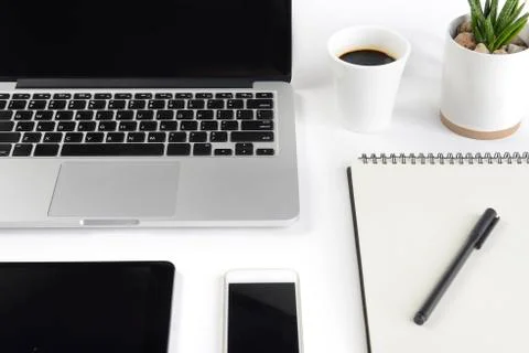 Office table with laptop computer, notebook, digital tablet and smartphone on Stock Photos