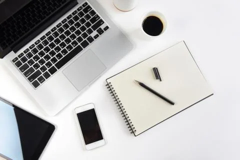 Office table with laptop computer, notebook, digital tablet and smartphone on Stock Photos