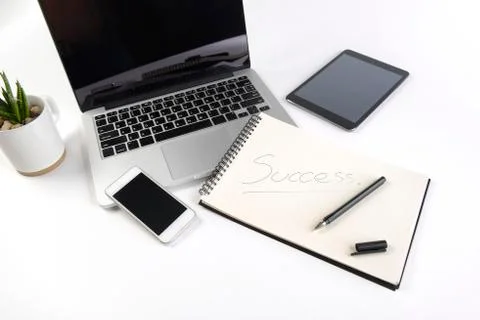 Office table with laptop computer, notebook, digital tablet and smartphone on Stock Photos